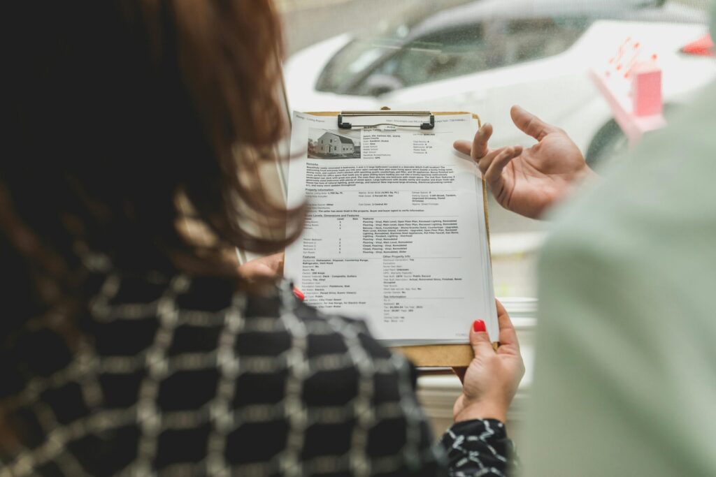 a person reading and holding document files on clip board