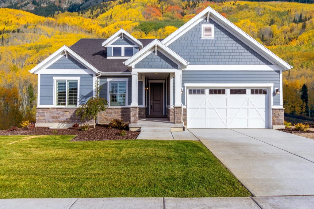 facade of a suburban family house with autumnal trees in the back