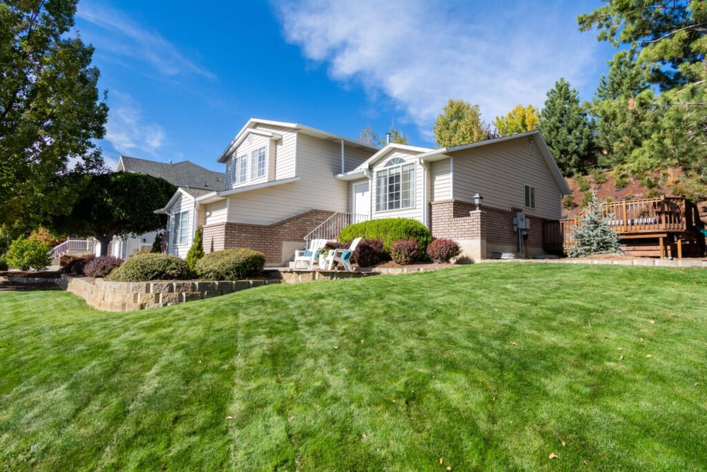 a beautiful house with lush garden under blue sky