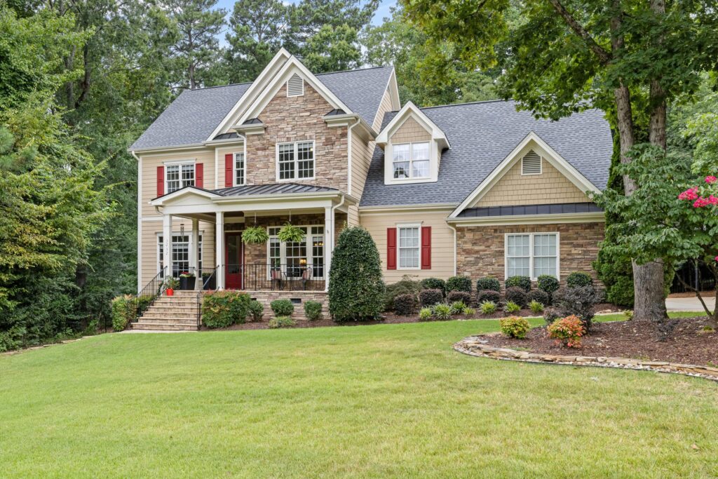 a two story house with a well maintained front yard